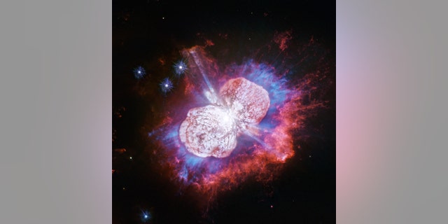 This Hubble Space Telescope image of the giant, petulant star Eta Carinae is yielding new surprises. Telescopes such as Hubble have monitored the super-massive star for more than two decades. The star, the largest member of a double-star system, has been prone to violent outbursts, including an episode in the 1840s during which ejected material formed the bipolar bubbles seen here. Now, using Hubble's Wide Field Camera 3 to probe the nebula in ultraviolet light, astronomers have uncovered the glow of magnesium embedded in warm gas (shown in blue) in places they had not seen it before. (Credit: NASA, ESA, N. Smith (University of Arizona) and J. Morse (BoldlyGo Institute))