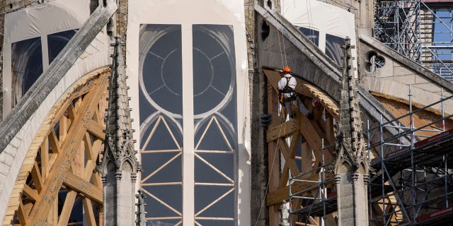 Workers are pictured during preliminary work to repair the fire damage at the Notre-Dame de Paris Cathedral, in Paris, France, Wednesday, July 24, 2019.