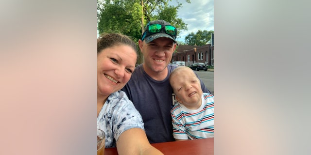 Grayson, with his parents, is the family's youngest of four siblings and they call him their "miracle."