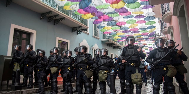 Police block protesters from advancing to La Fortaleza governor's residence in San Juan, Puerto Rico, Sunday. Protesters demanded Gov. Ricardo Rosselló step down for his involvement in a private chat in which he used profanities. (AP Photo/Carlos Giusti)