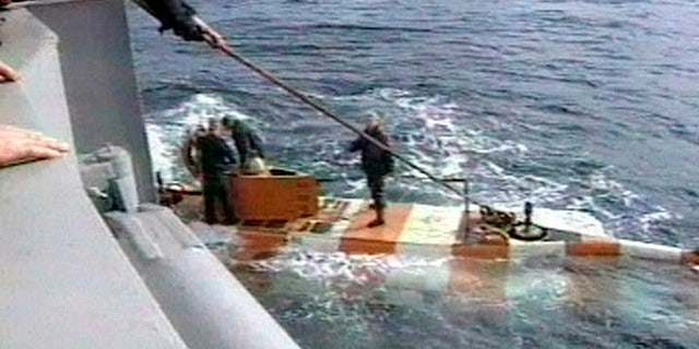 In this video grab provided by the RU-RTR Russian television via APTN , Russia rescue personnel return from a dive in a mini submarine to the Kursk on the sea bed in the Barents Sea, Russia. (RU-RTR Russian Television via AP)