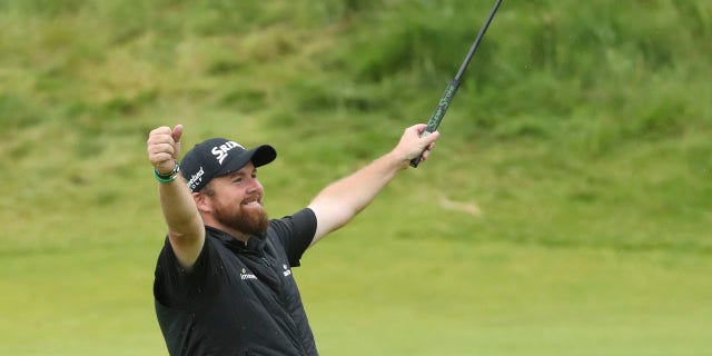Ireland's Shane Lowry lifts his club to celebrate as he wins the British Open Golf Championships at Royal Portrush in Northern Ireland, Sunday, July 21, 2019.