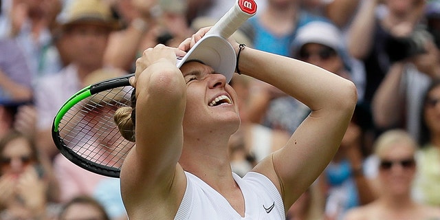 Romania's Simona Halep celebrates after defeating United States' Serena Williams during the women's singles final match on day twelve of the Wimbledon Tennis Championships in London, Saturday, July 13, 2019. (AP Photo/Kirsty Wigglesworth)