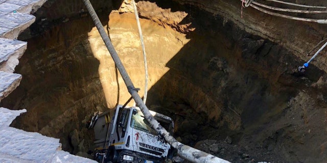 A garbage truck plunged into a massive sinkhole in the Italian city of Naples.