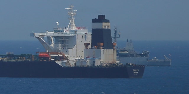 A British Royal Navy patrol vessel guards the oil supertanker Grace 1.