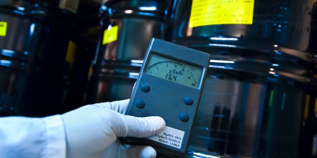 Man checking radiation with Geiger counter. 