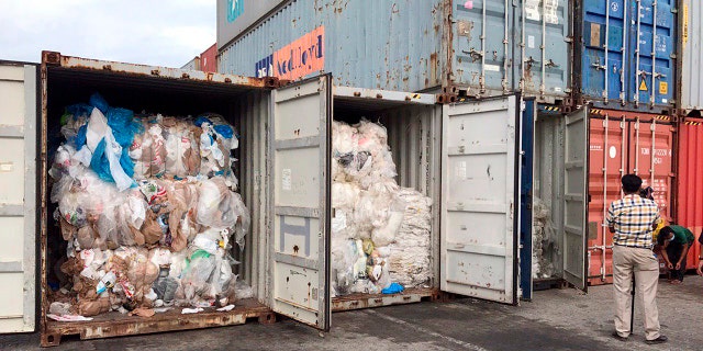 In this Tuesday, July 16, 2019, photo, containers loaded with plastic waste are placed at country beach city, Sihanoukville Port, southwest of Phnom Penh, Cambodia. (AP Photo/Sea Seakleng)
