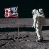 Astronaut Edwin E. Aldrin Jr., the lunar module pilot of the first lunar landing mission, poses for a photograph beside the deployed United States flag during an Apollo 11 extravehicular activity on the lunar surface.