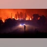 Members of the emergency services try to extinguish a wildfire near Cardigos village, in central Portugal, July 21, 2019. 