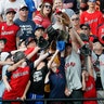Fans battle for a home run ball during batting practice for the MLB All-Star baseball game in Cleveland, July 8, 2019. 