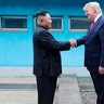 North Korean leader Kim Jong Un and President Donald Trump shake hands over the military demarcation line at the border village of Panmunjom in Demilitarized Zone, June 30, 2019. 