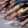 Swimmers leap into the water at the start of the 5km mixed relay open water swim at the World Swimming Championships in Yeosu, South Korea, July 18, 2019. 