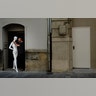 A man stands with a mannequin in a doorway in Pamplona, northern Spain, July 22, 2019. 