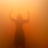 A visitor tries to walk through a room full of fog called 'Your Blind Passenger' as part of the exhibition Olafur Eliasson: 'In real life' at the Tate Modern Gallery in London, July 9, 2019. 