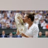 Romania's Simona Halep kisses the trophy after defeating Serena Williams in the women's singles final at the Wimbledon Tennis Championships in London, July 13, 2019. 