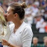 Romania's Simona Halep kisses the trophy after defeating Serena Williams in the women's singles final at the Wimbledon Tennis Championships in London, July 13, 2019. 