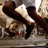 Revelers run next to bulls from the Cebada Gago ranch, during the running of the bulls at the San Fermin Festival, in Pamplona, Spain, July 8, 2019. 