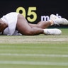 Serena Williams of the U.S. falls attempting to return the ball to Alison Riske during a women's quarterfinal match at the Wimbledon Tennis Championships in London, July 9, 2019. (AP Photo/Kirsty Wigglesworth)