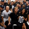 Britain's Prince Harry and Meghan, Duchess of Sussex pose for a picture with players of the New York Yankees before their game against the Boston Red Sox in London, June 29, 2019. 