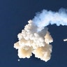 The Orion test capsule and a Minotaur 4 booster rocket, fall to the Earth during a full-stress launch abort test by NASA in Cape Canaveral, Fla., July 2, 2019. 