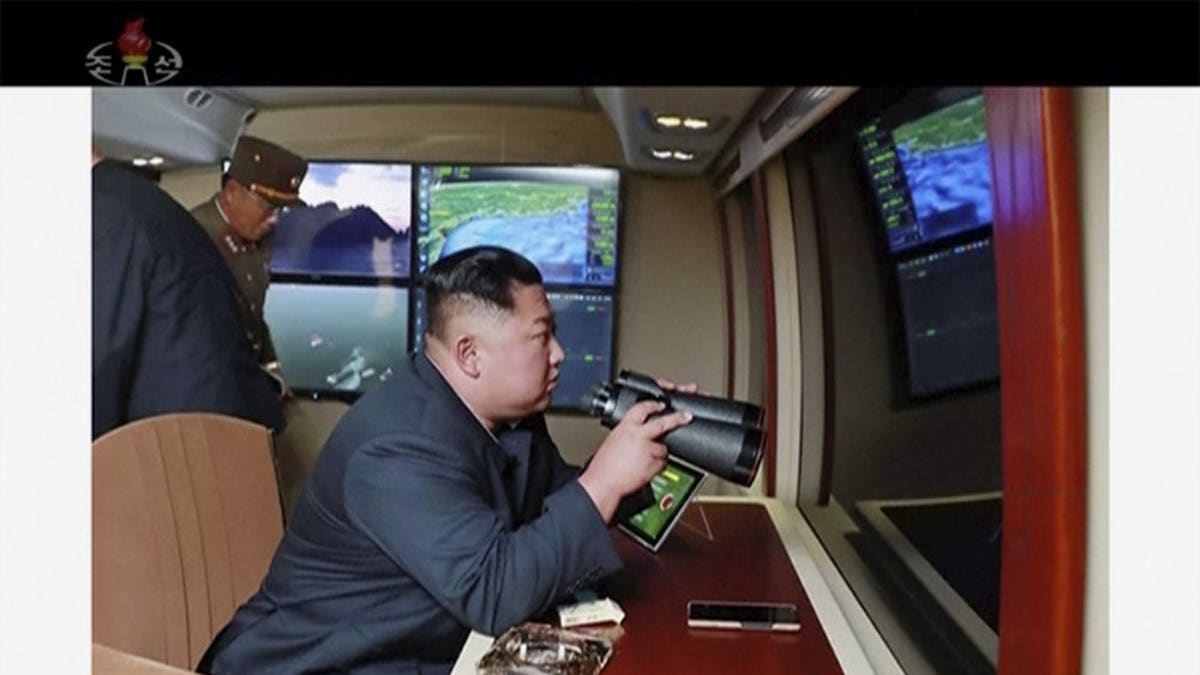 In this image made from video of a still image broadcasted by North Korea's KRT on Thursday, Aug. 1, 2019, North Korean leader Kim Jong Un, equipped with binoculars, supervises a rocket launch test. North Korea said Thursday, Aug. 1, leader Kim supervised the first test firing of a new multiple rocket launcher system that could potentially enhance its ability to strike targets in South Korea and U.S. military bases there.