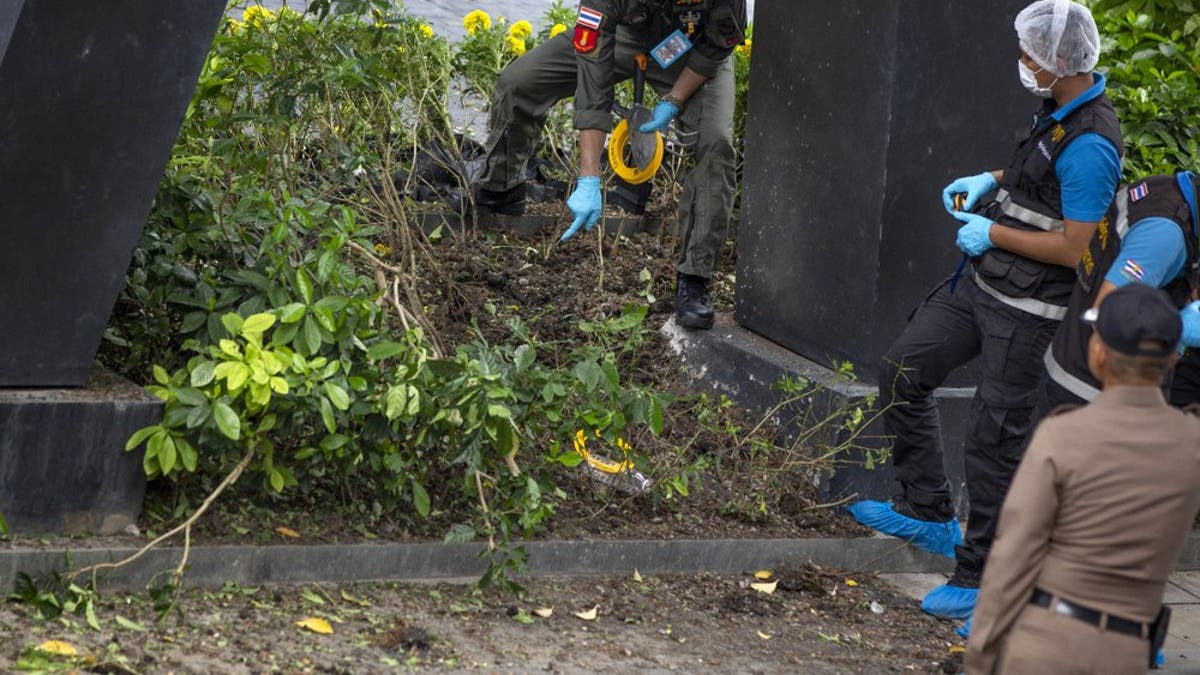 Thai investigators examine a site of an explosion in Bangkok, Thailand, Friday, Aug 2, 2019. Thai Prime Minister Prayuth Chan-o-cha on Friday ordered an investigation into several small bombings in Bangkok that took place as Thailand was hosting a high-level meeting attended by U.S. Secretary of State Mike Pompeo and his counterparts from China and several Asia-Pacific countries.