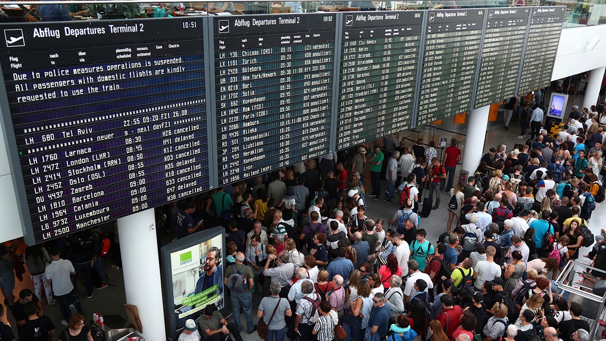 People wait inside the Munich Airport in Munich, Germany, Tuesday, Aug. 27, 2019. Munich Airport says it has closed some of its terminals because a person has likely entered the "clean area" through an emergency exit door. The international airport tweeted Tuesday morning that terminal 2 and areas B and C or terminal 1 had been closed for police operations.(AP Photo/Matthias Schrader)