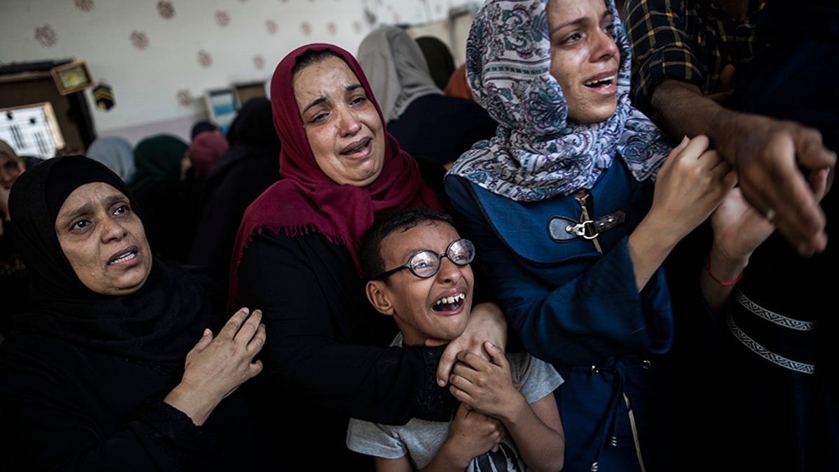 Relatives mourning the death of Palestinian Hamas militant Mohammad Abu Namous during his Gaza funeral Sunday.