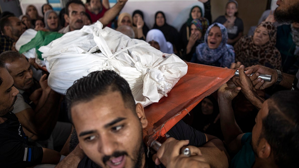 Mourners carrying the body of Palestinian Hamas militant Mohammad Abu Namous out of the family home during his funeral Sunday.