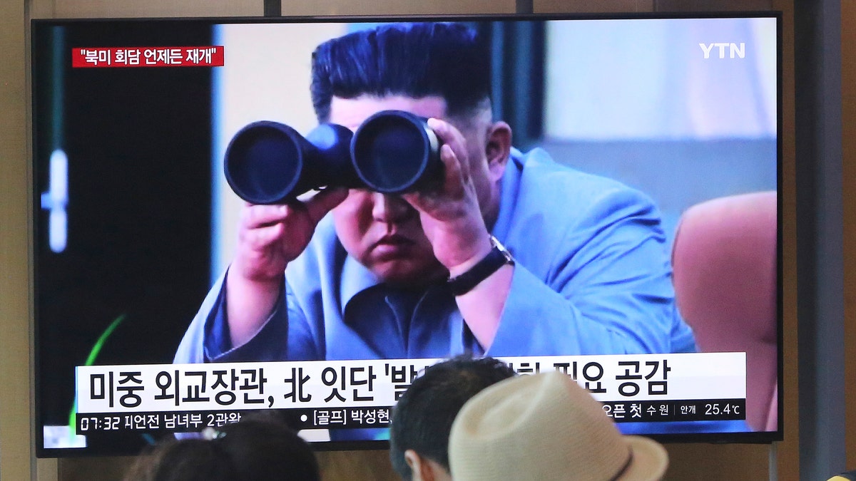 People watch a TV showing a file footage of North Korean leader Kim Jong Un during a news program at the Seoul Railway Station in Seoul, South Korea, Friday, Aug. 2, 2019. The sign reads "North Korea launches frequently." (Associated Press)