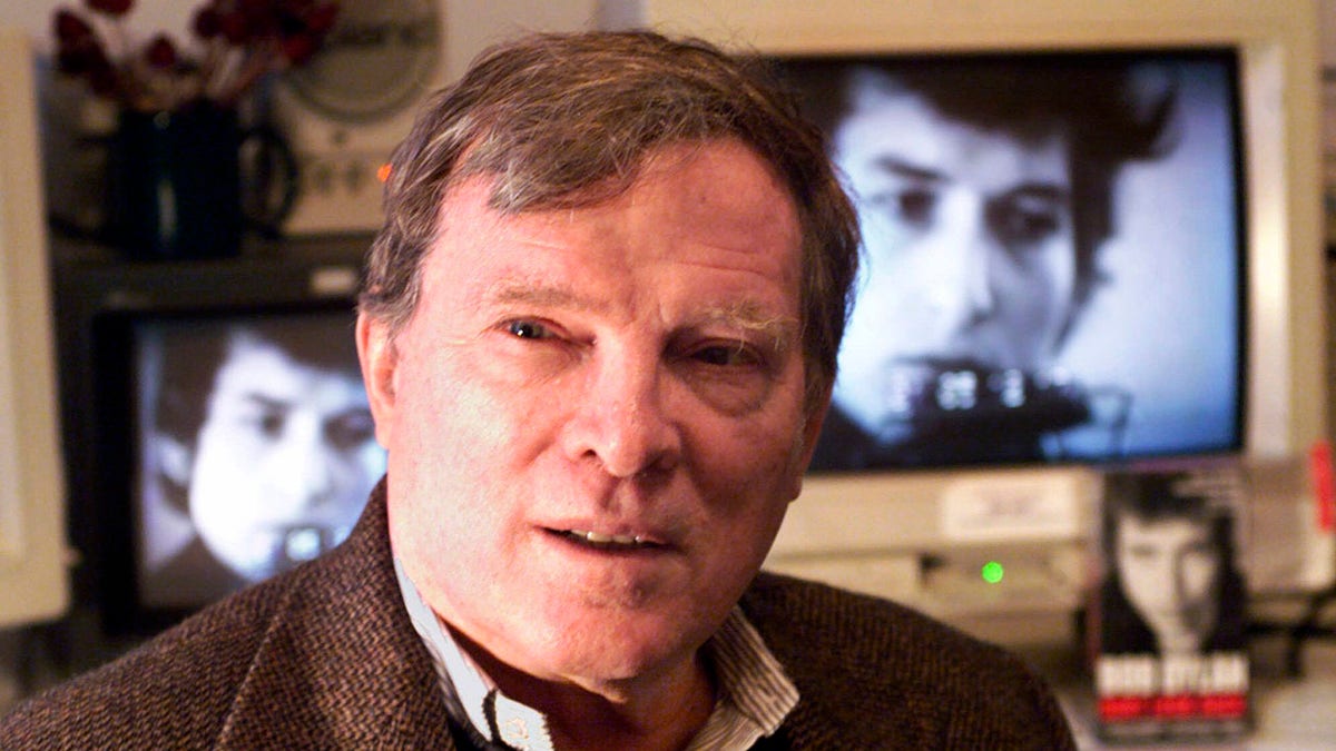 Documentary filmmaker D.A. Pennebaker is flanked by 35-year-old images of Bob Dylan as Pennebaker sits in his New York editing suite, Jan. 27, 2000. (Associated Press)