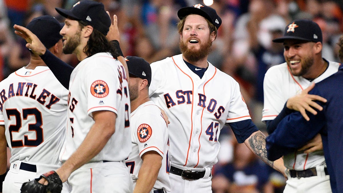 Houston Astros relief pitcher Chris Devenski, second from right, and teammates celebrate the team's 9-0 win over the Seattle Mariners, with a four-pitcher combined no-hitter, in a baseball game Saturday, Aug. 3, 2019, in Houston. (Associated Press)