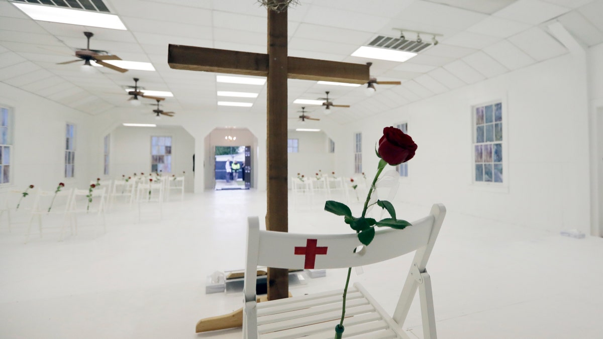 FILE - In this Nov. 12, 2017, file photo, a rose rests on a chair during a memorial for the victims of the shooting at Sutherland Springs First Baptist Church at the church in Sutherland Springs, Texas. At the church where more than two dozen people were killed by a gunman in 2017, Pastor Frank Pomeroy sought to boost his followers' resolve with upbeat remarks at Sunday's service. He urged them not to live "in a spirit of fear." (AP Photo/Eric Gay, File)