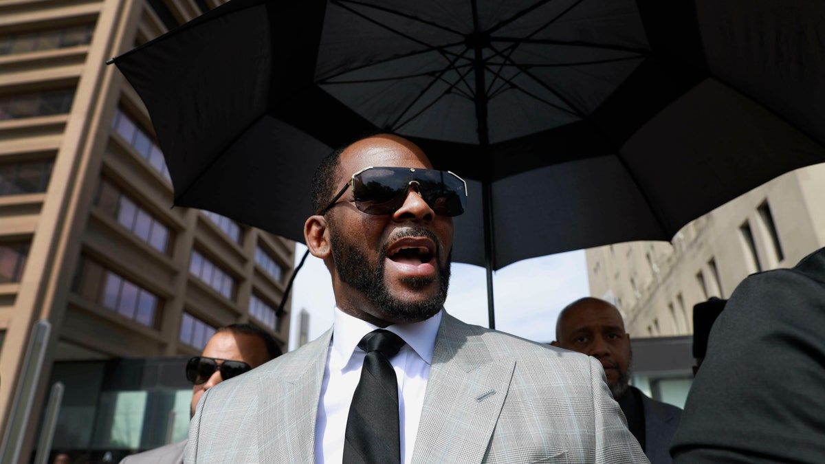 In this June 6, 2019, photo, musician R. Kelly leaves the Leighton Criminal Court building in Chicago. Minnesota authorities charged singer R. Kelly on Monday, Aug. 5, 2019, with two counts of prostitution and solicitation involving a girl under 18 in 2001. (AP Photo/Amr Alfiky, File)