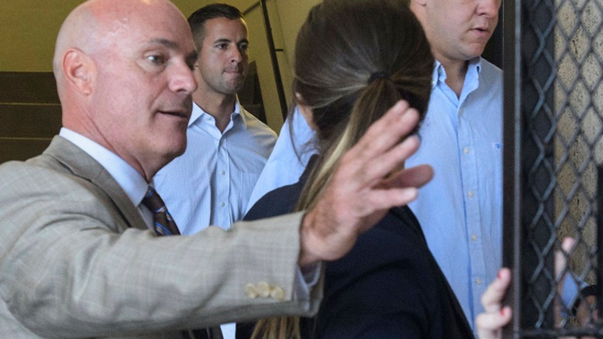 In this 2018 photo, New Orleans Police Department Officers John Galman, second left, and Spencer Sutton, right, arrive in New Orleans Municipal Court for a bail hearing with their lawyers. (Matthew Hinton/The Times-Picayune/The New Orleans Advocate via AP)