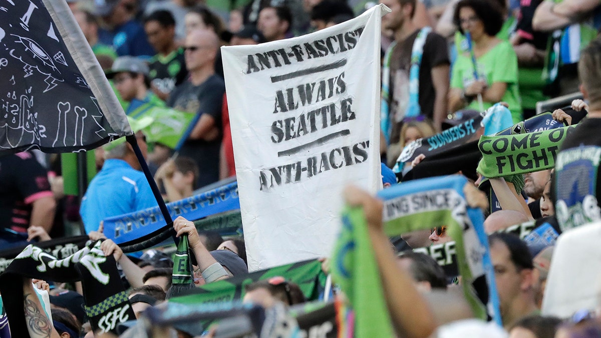 ​​​​​​​A sign that reads "Anti-Facist Always Seattle Anti-Racist" is displayed in the supporters section during an MLS soccer match between the Seattle Sounders and the Portland Timbers in Seattle, July 21, 2019. (Associated Press)
