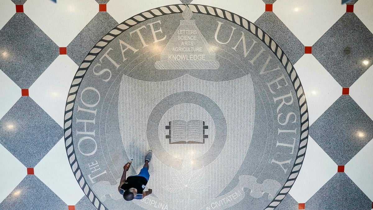 In this May 18, 2019 file photo, pedestrians pass through Ohio State University's student union in Columbus, Ohio. Ohio State University wants to trademark the word "The" when used as part of the school’s name on university merchandise.  (AP Photo/John Minchillo)