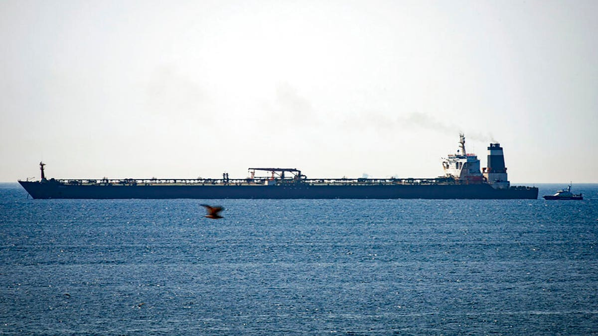 In this file photo dated Thursday, July 4, 2019, Grace 1 super tanker is anchored near a Royal Marine patrol vessel off the coast of the British territory of Gibraltar.