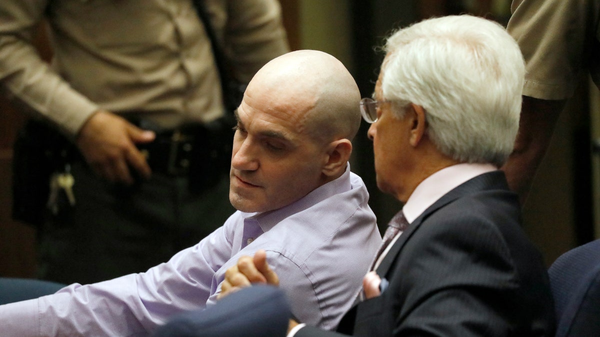 Michael Gargiulo, left, and his attorney Daniel Nardoni confer as Gargiulo's guilty verdicts on all counts are read in Los Angeles Superior Court Thursday, Aug. 15, 2019. A jury found Gargiulo guilty of fatally stabbing two women and attempting to kill a third in their Southern California homes.   Gargiulo, is also awaiting trial for a similar killing in Illinois in 1993.  (Al Seib/Los Angeles Times via AP, Pool)