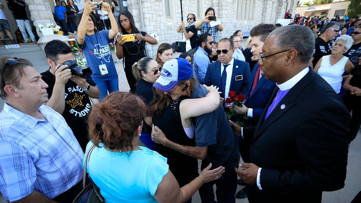 Supporters greeting Antonio Basco, center right, outside his partner's funeral. (AP Photo/Jorge Salgado)