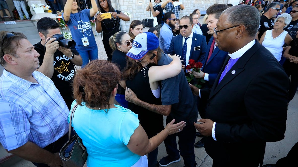 Supporters greeting Antonio Basco, center right, outside his partner's funeral. (AP Photo/Jorge Salgado)