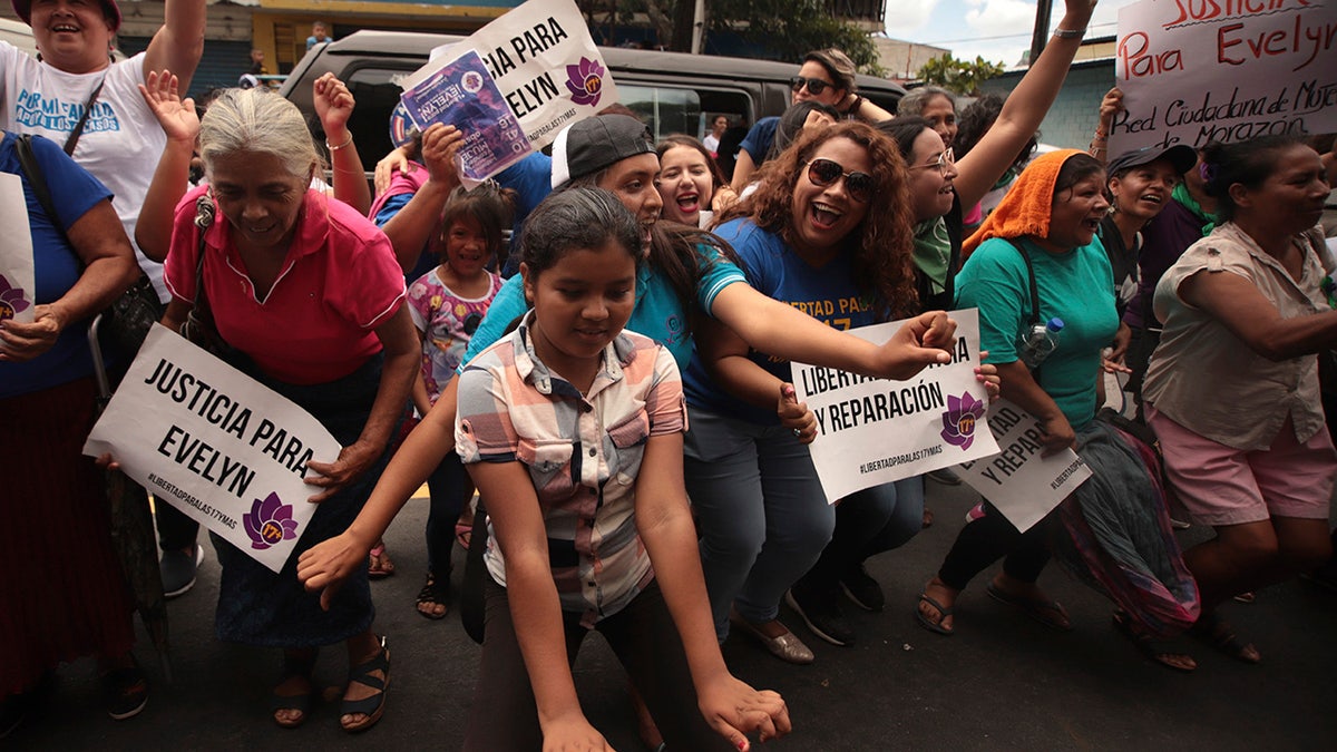 Women and girls celebrate outside court where Evelyn Hernandez was acquitted on charges of aggravated homicide in her retrial related to the loss of a pregnancy in 2016, in Ciudad Delgado on the outskirts of San Salvador, El Salvador, Monday, Aug. 19, 2019. 