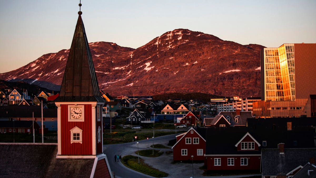FILE - In this Monday, July. 31, 2017 file photo the sun sets over Nuuk, Greenland. (AP Photo/David Goldman, File)