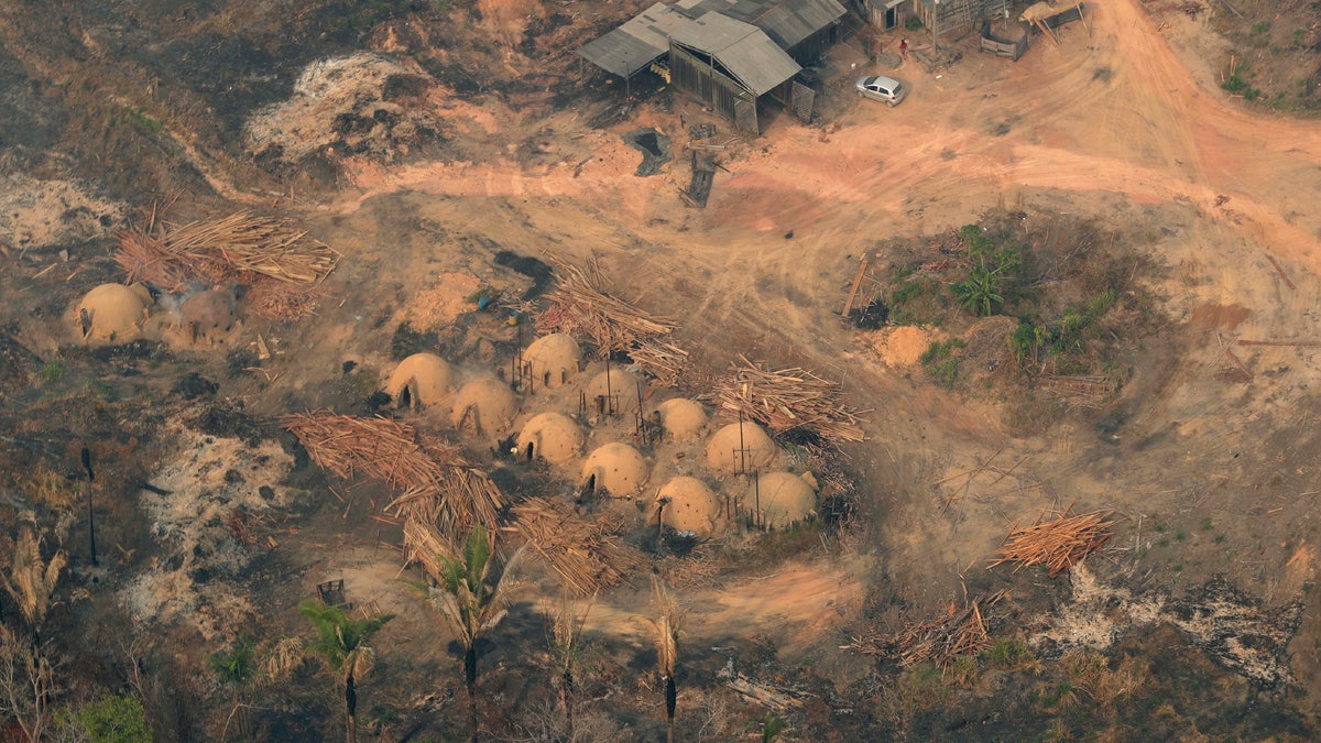 Charcoal-making furnaces and wooden planks are seen from the air, in the city of Jaci Parana, Rondonia state on Saturday. The defense and environment ministers have outlined plans to battle the blazes that have prompted an international outcry as well as demonstrations in Brazil against President Jair Bolsonaro's handling of the environmental crisis. (AP Photo/Eraldo Peres)