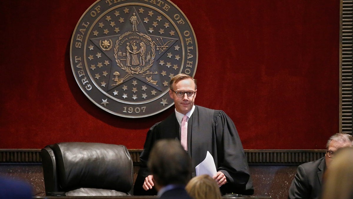 Judge Thad Balkman arrives to give his decision in the Opioid Lawsuit in Norman, Okla., Monday, Aug. 26, 2019. Balkman found Johnson & Johnson and its subsidiaries helped fuel the state's opioid drug crisis and ordered the consumer products giant to pay $572 million to help abate the problem in the coming years. (AP Photo/Sue Ogrocki, Pool)