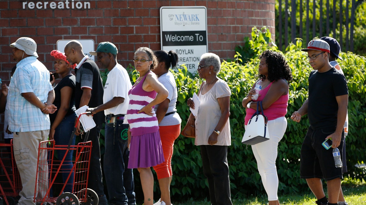 City residents line up at the Boylan Street Recreation Center with cases of bottled water, Monday, Aug. 12, 2019, in Newark, N.J., after recent U.S. Environmental Protection Agency tests showed elevated levels of lead in the drinking water in some areas. (Associated Press)