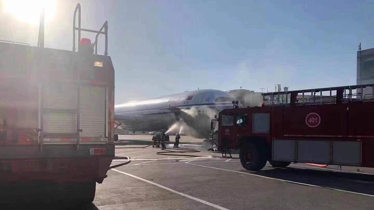 The plane was scheduled for a 5:10 p.m. departure, local time, when the smoke began pouring from both the front and back of the plane.