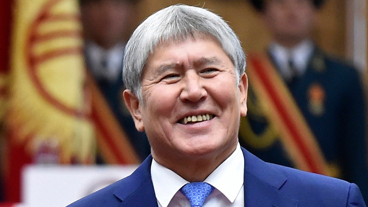 In this Friday, Nov. 24, 2017 file photo, former President Almazbek Atambayev greets the audience with President-elect Sooronbai Jeenbekov, during the presidential inauguration ceremony in Bishkek, Kyrgyzstan. 