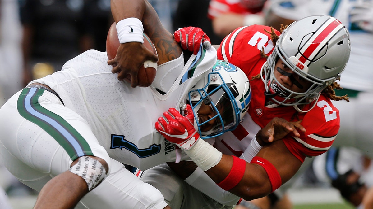 FILE - In this Sept. 22, 2018, file photo, Ohio State defensive end Chase Young, right, sacks Tulane quarterback Jonathan Banks during the first half of an NCAA college football game, in Columbus, Ohio. Chase Young is known to lead with his mouth. Being the loudest Buckeye on the field is part of the reason his teammates elected him a captain this season. (AP Photo/Jay LaPrete, File)