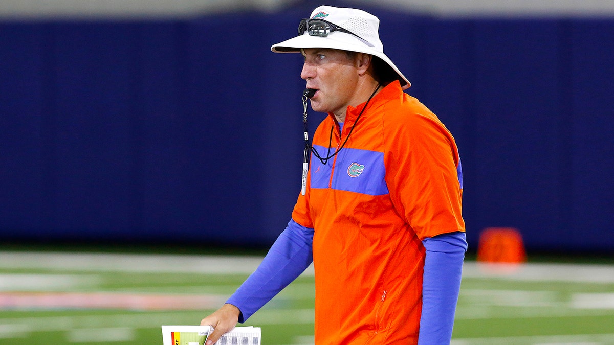 Florida head coach Dan Mullen walks during an NCAA college football practice in Gainesville, Fla., Friday, July 26, 2019. (Brad McClenny/The Gainesville Sun via AP)